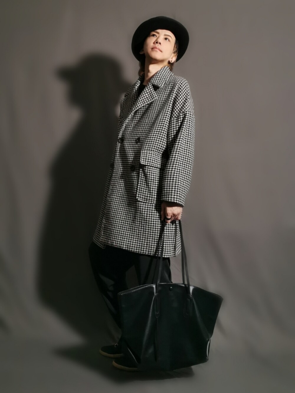 その他のその他アウター、ブラック系のトートバッグ、ブラック系のスリッポンを着用したメンズの冬コーディネートの2枚目の写真