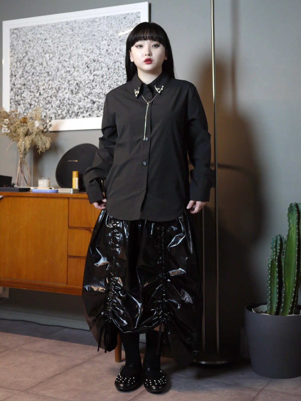 ブラック系のシャツ/ブラウス、ブラック系のスカート、シルバー系のネックレスを着用したレディースの秋コーディネートの2枚目の写真