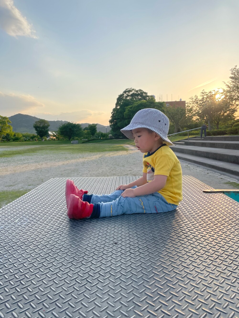 イエロー系のTシャツ/カットソー、レッド系のスニーカー、ホワイト系のハットを着用したキッズの夏コーディネートの2枚目の写真