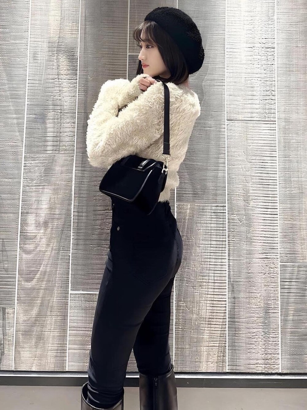 ベージュ系のニット/セーター、ブラック系のショルダーバッグ、ブラック系のハンチング/ベレー帽を着用したレディースの冬コーディネートの2枚目の写真