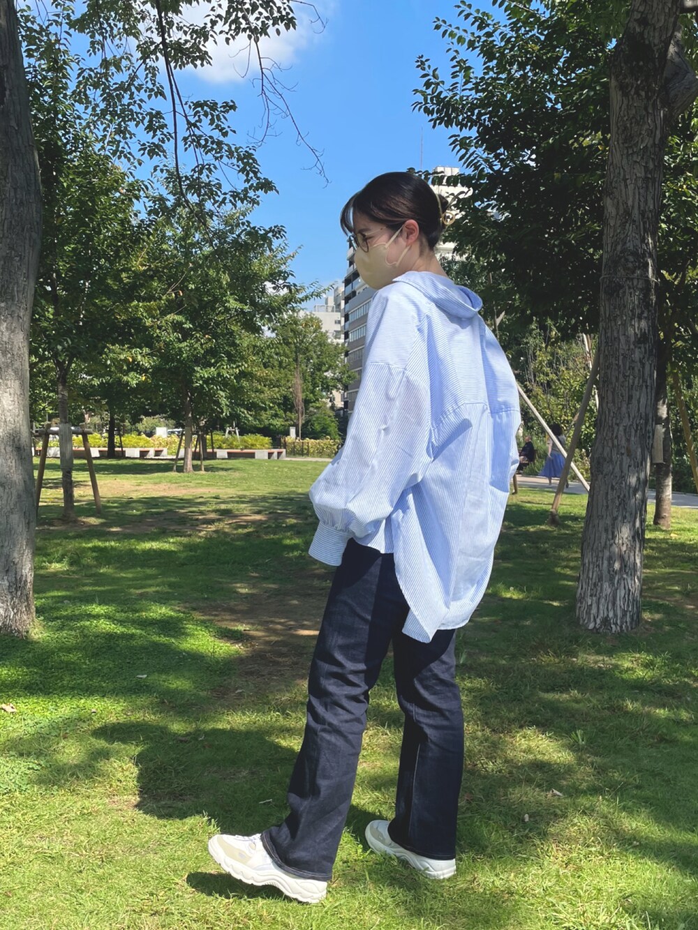 ブルー系のデニムパンツ、ホワイト系のTシャツ/カットソー、ブルー系のシャツ/ブラウスを着用したレディースの秋コーディネートの2枚目の写真