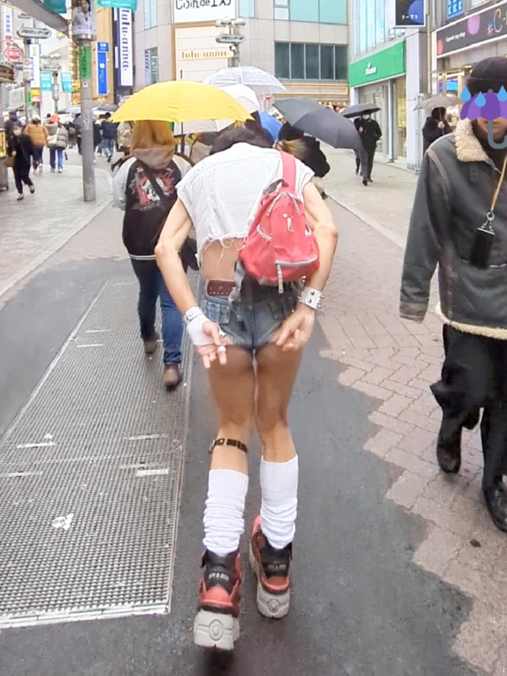 レッド系のスニーカー、ホワイト系のベスト、ブラック系のタンクトップを着用したメンズの冬コーディネートの3枚目の写真