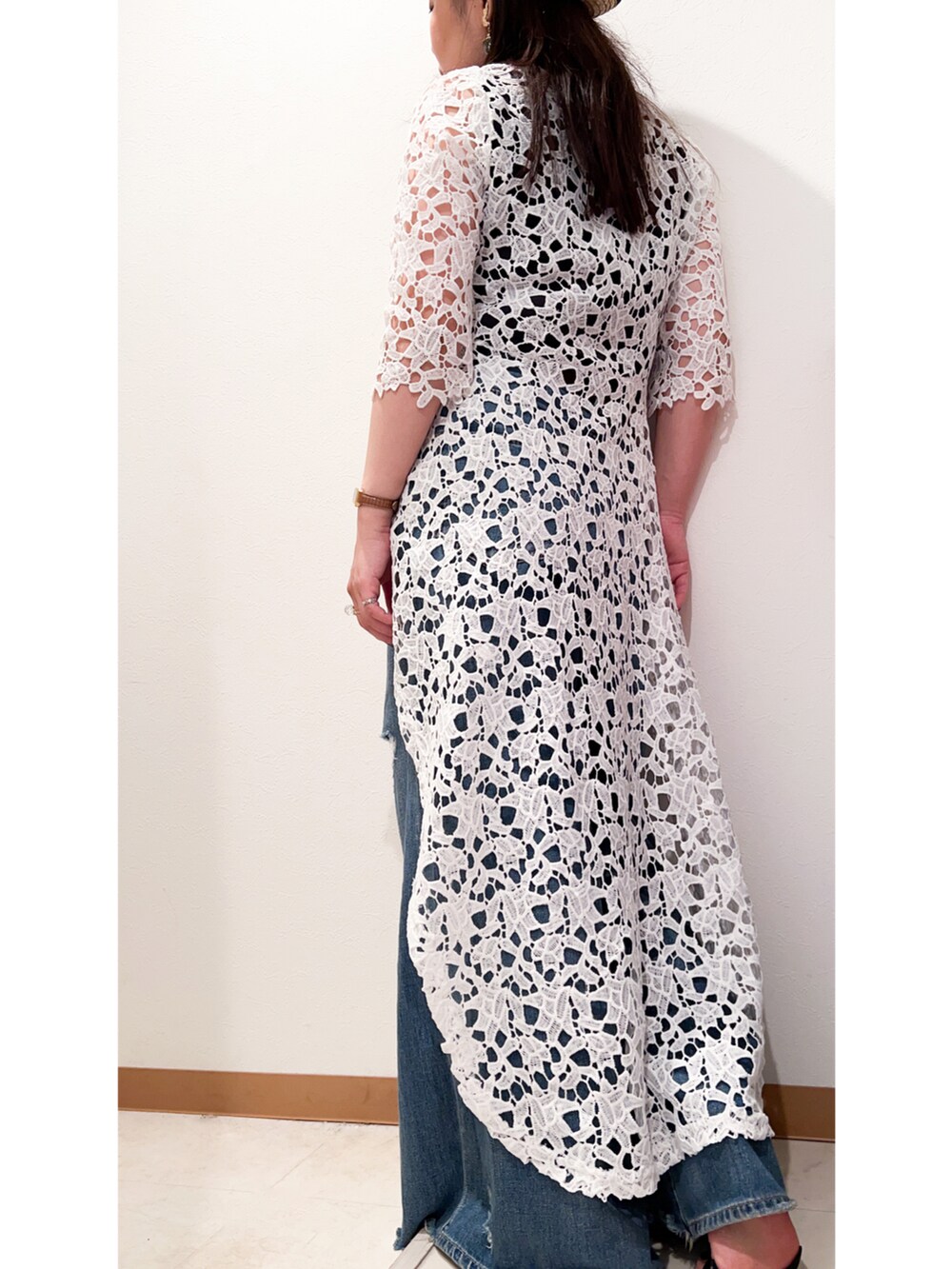 ホワイト系のワンピース、ブルー系のデニムパンツ、ベージュ系のハットを着用したレディースの夏コーディネートの2枚目の写真