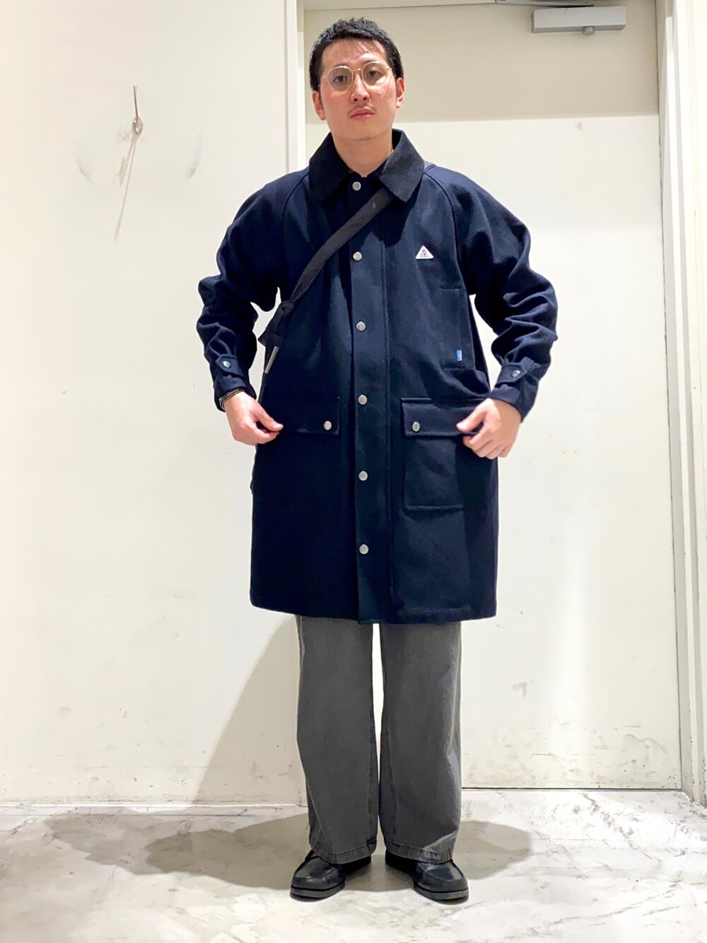 ブラック系のショルダーバッグ、ブルー系のその他アウター、ブラック系のデニムパンツを着用したメンズの秋コーディネートの2枚目の写真