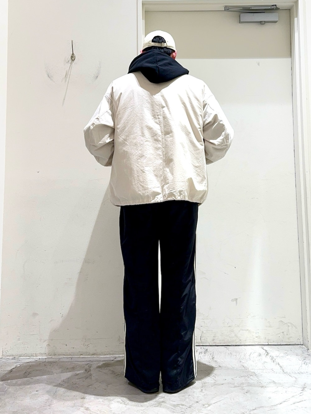 ホワイト系のTシャツ/カットソー、ブラック系のパーカー、ホワイト系のモッズコートを着用したメンズの春コーディネートの4枚目の写真