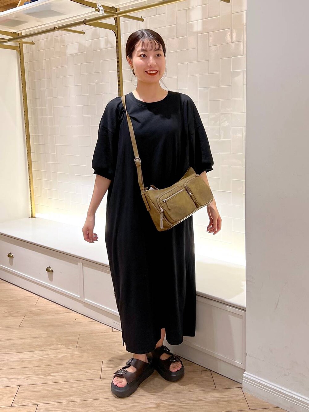 ブラウン系のサンダル、ブラック系のワンピース、ブラウン系のショルダーバッグを着用したレディースの夏コーディネートの3枚目の写真