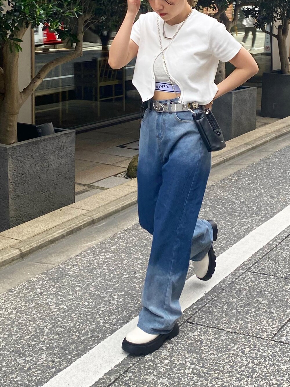 ホワイト系のTシャツ/カットソー、ブルー系のデニムパンツ、ホワイト系のブーツを着用したレディースの春コーディネートの2枚目の写真