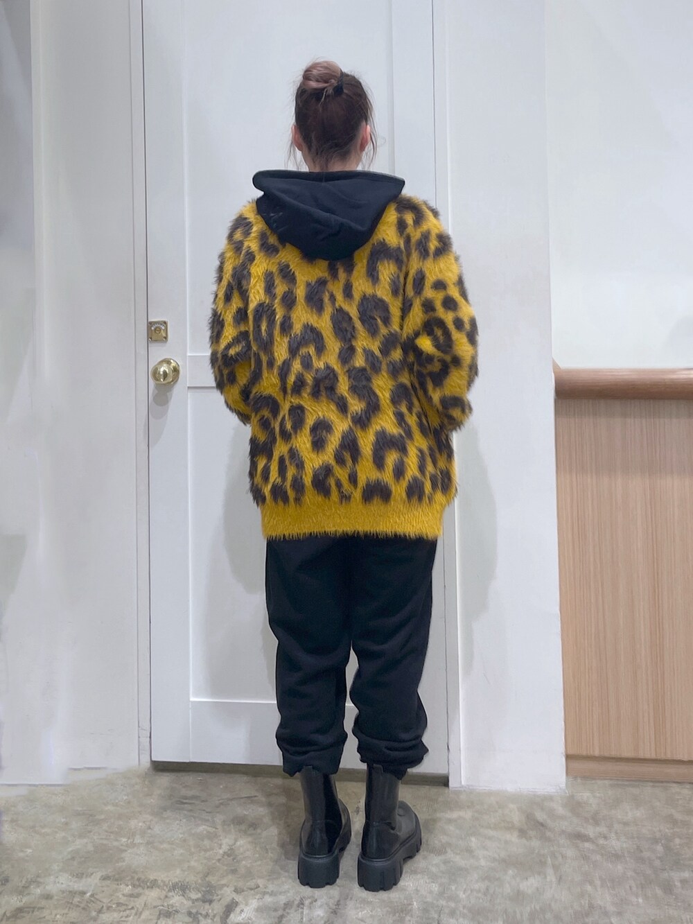 ブラック系のパーカー、ベージュ系のカーディガン/ボレロ、ブラック系のスウェットパンツを着用したレディースの秋コーディネートの3枚目の写真