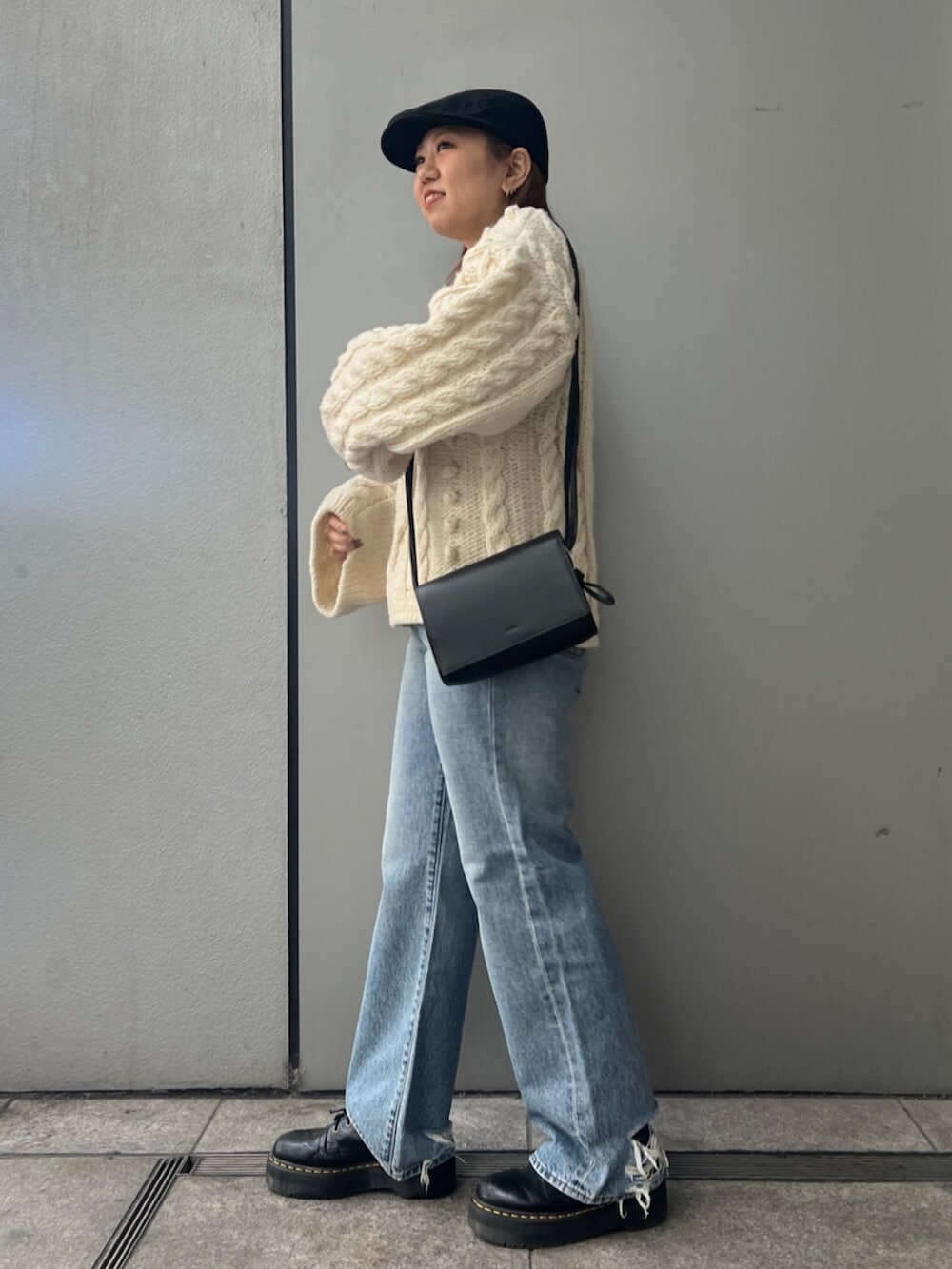 ホワイト系のTシャツ/カットソー、ホワイト系のニット/セーター、ブルー系のデニムパンツを着用したレディースの冬コーディネートの3枚目の写真