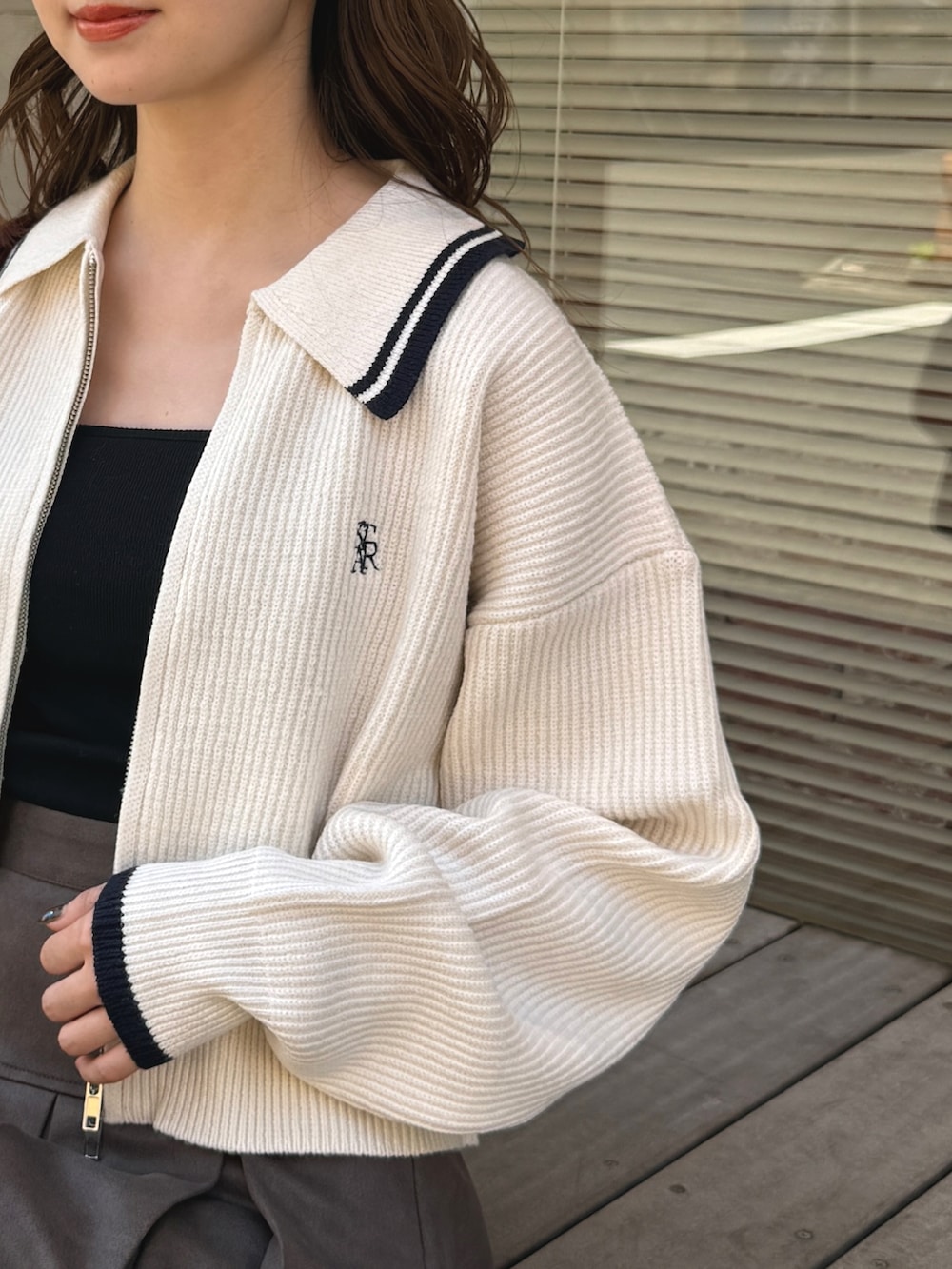 ホワイト系のニット/セーター、ブラウン系のスカートを着用したレディースの秋コーディネートの4枚目の写真