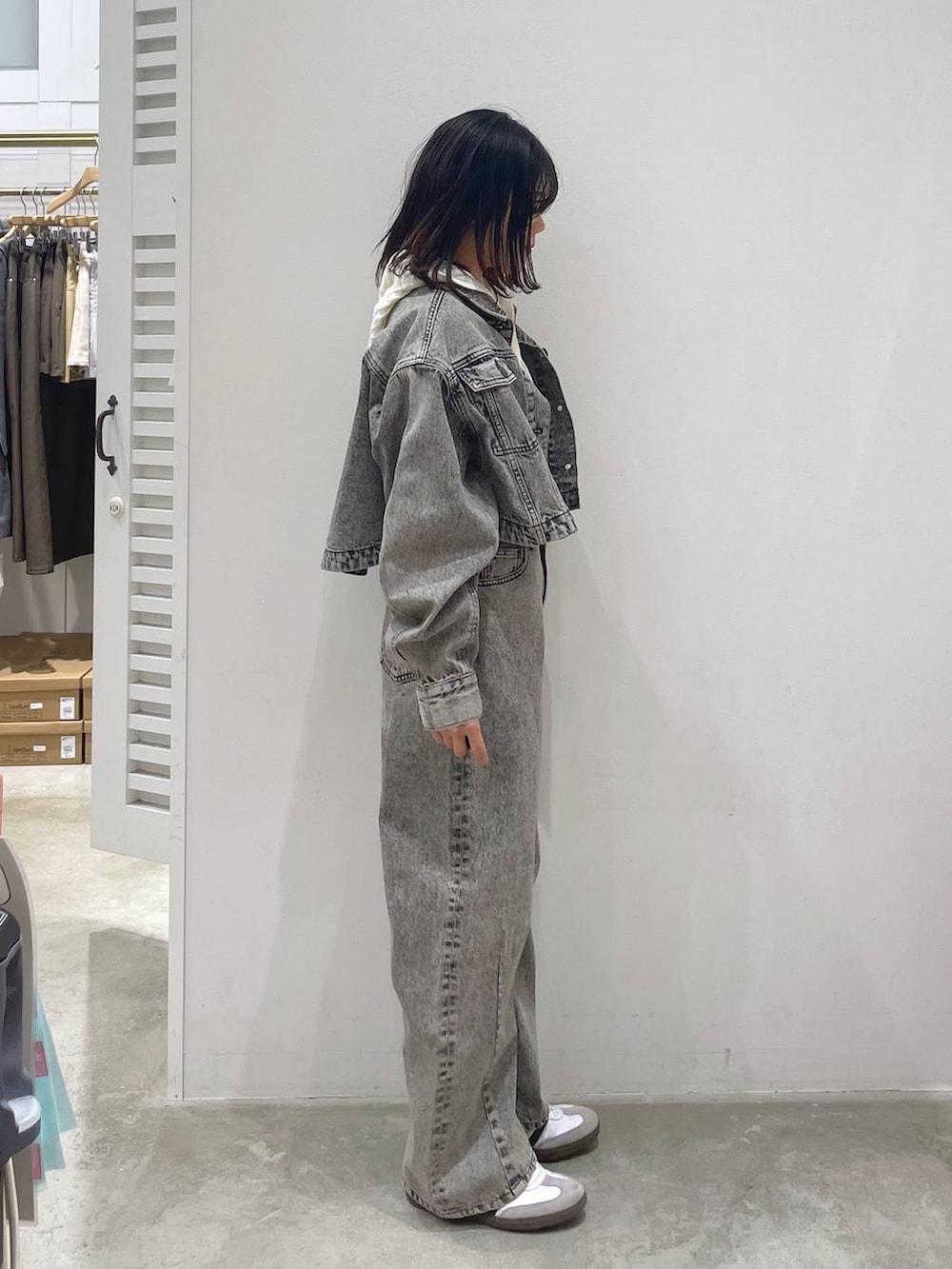 グレー系のデニムジャケット、グレー系のデニムパンツ、ホワイト系のニット/セーターを着用したレディースの冬コーディネートの2枚目の写真