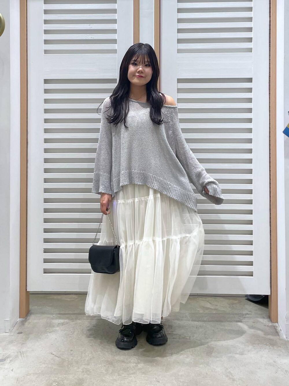 ホワイト系のワンピース、ブラック系のローファー、ブラック系のショルダーバッグを着用したレディースの春コーディネートの2枚目の写真