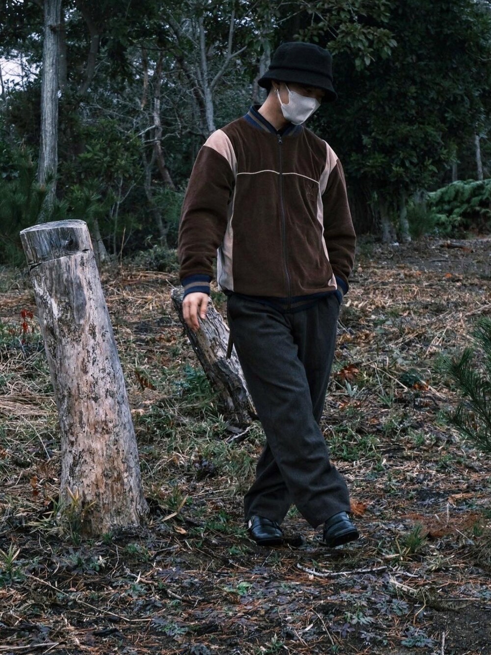 ブラウン系のトップス、ブラウン系のスラックス、ブラック系のローファーを着用したメンズの冬コーディネートの4枚目の写真