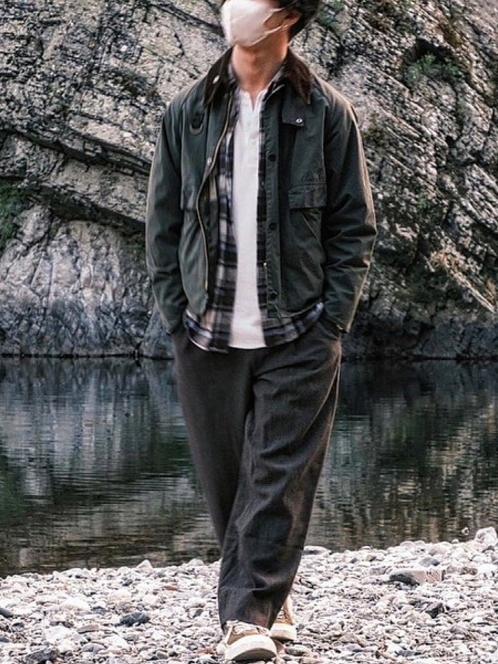 ブラウン系のスラックス、グリーン系のスニーカー、グリーン系のミリタリージャケットを着用したメンズの秋コーディネートの2枚目の写真