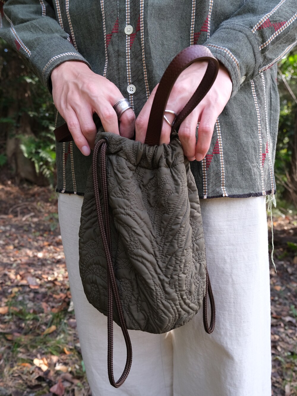 グリーン系のボディバッグ/ウエストポーチ、グリーン系のシャツ/ブラウス、ホワイト系のその他パンツを着用したメンズの秋コーディネートの2枚目の写真