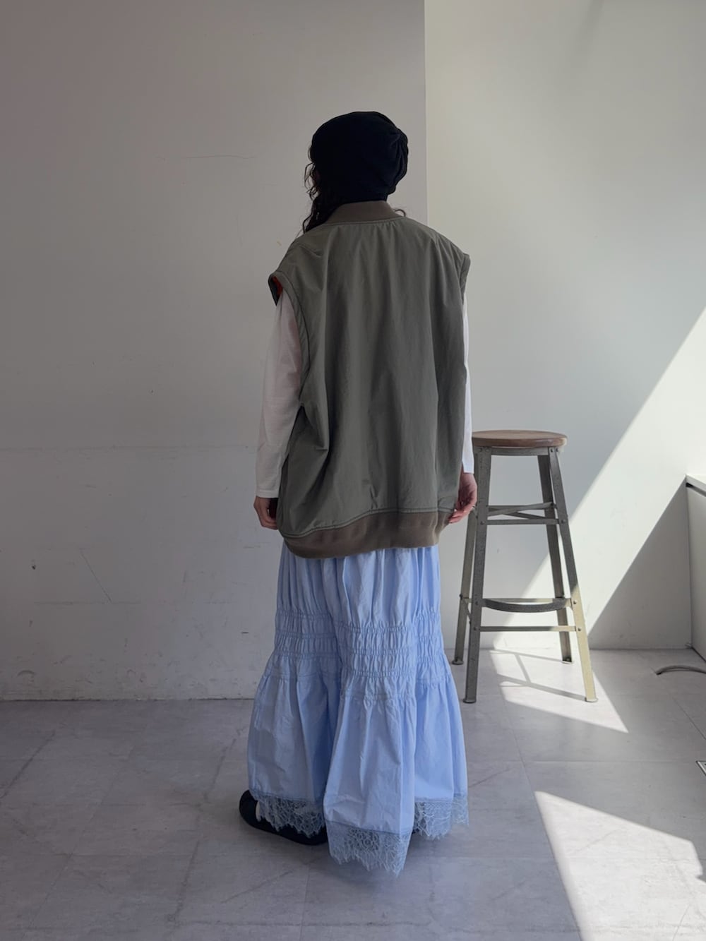 グリーン系のMA-1、ホワイト系のTシャツ/カットソー、ブルー系のスカートを着用したレディースの春コーディネートの3枚目の写真