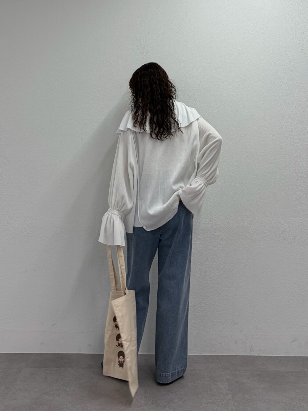 ホワイト系のTシャツ/カットソー、ブルー系のデニムパンツ、ブラック系のパンプスを着用したレディースの春コーディネートの3枚目の写真