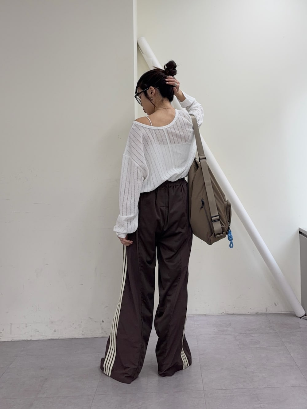 ホワイト系のTシャツ/カットソー、ブラウン系のスウェットパンツ、ブラウン系のパンプスを着用したレディースの冬コーディネートの4枚目の写真