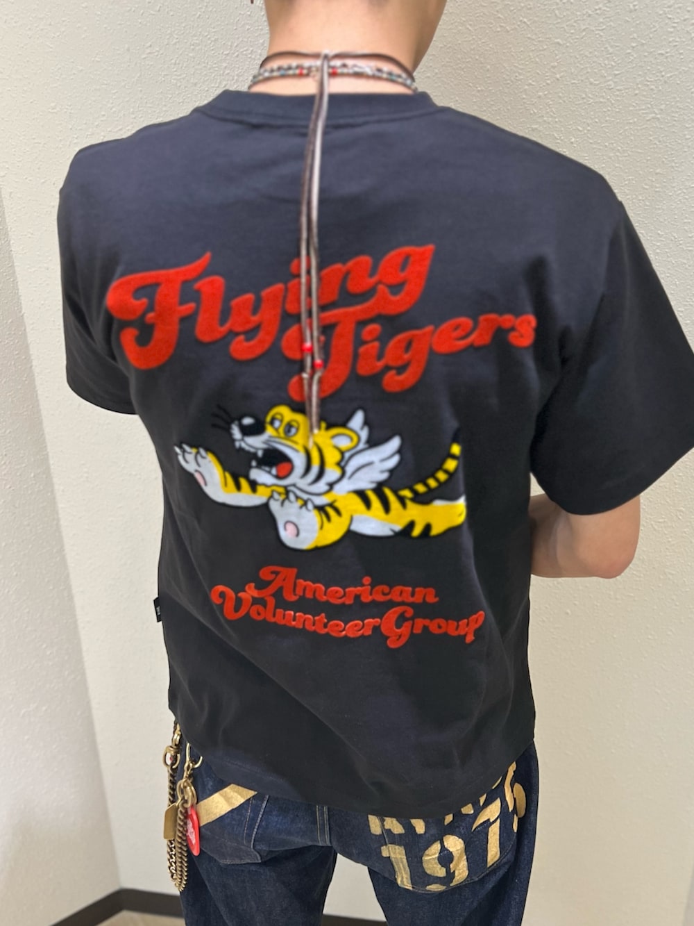 ブラック系のTシャツ/カットソー、ブルー系のデニムパンツを着用したメンズの夏コーディネートの3枚目の写真