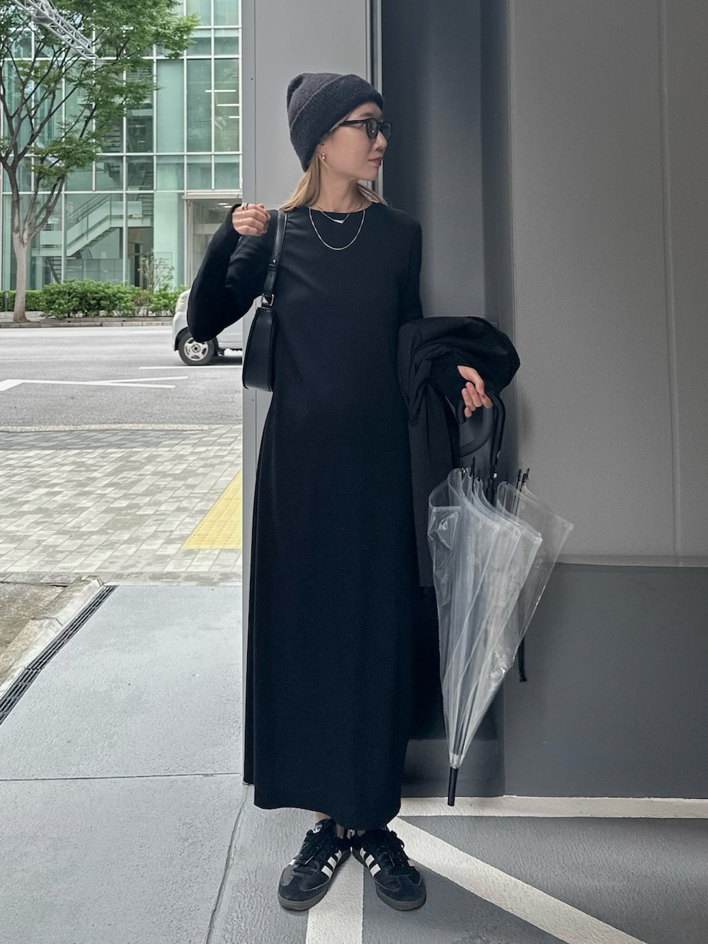 ブラック系のテーラードジャケット、ブラック系のワンピース、ブラック系のスニーカーを着用したレディースの秋コーディネートの4枚目の写真