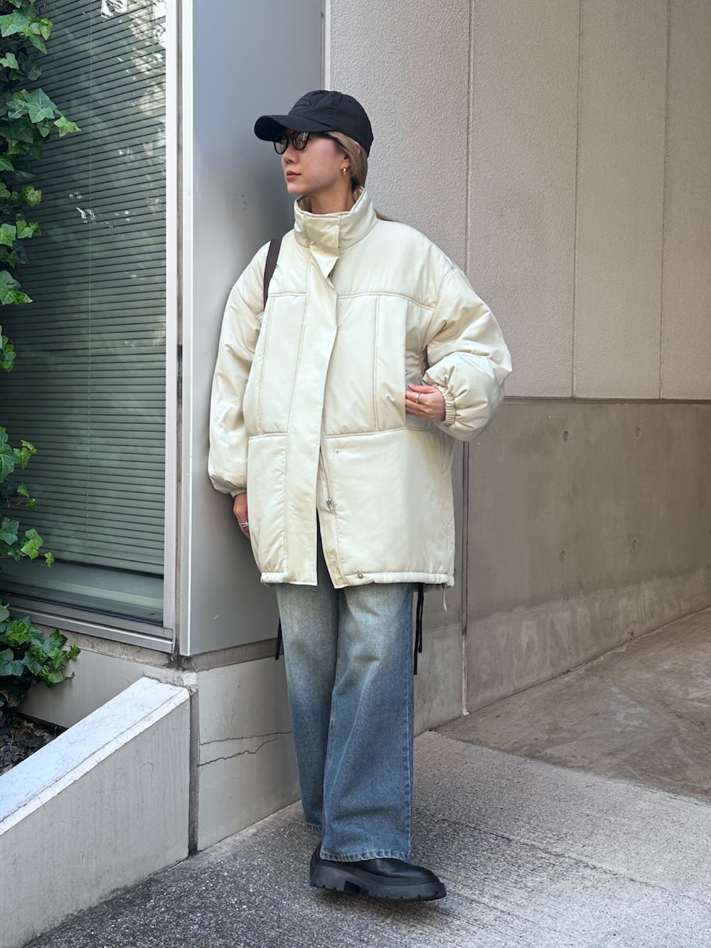 ベージュ系のその他アウター、ブルー系のデニムパンツ、ブラウン系のトートバッグを着用したレディースの冬コーディネートの3枚目の写真