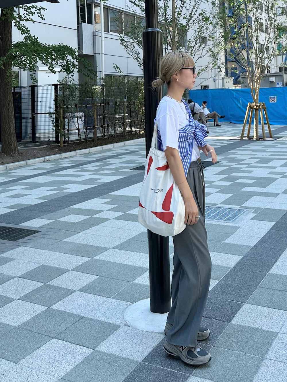 ホワイト系のTシャツ/カットソー、ブルー系のシャツ/ブラウス、グレー系のスラックスを着用したレディースの夏コーディネートの4枚目の写真