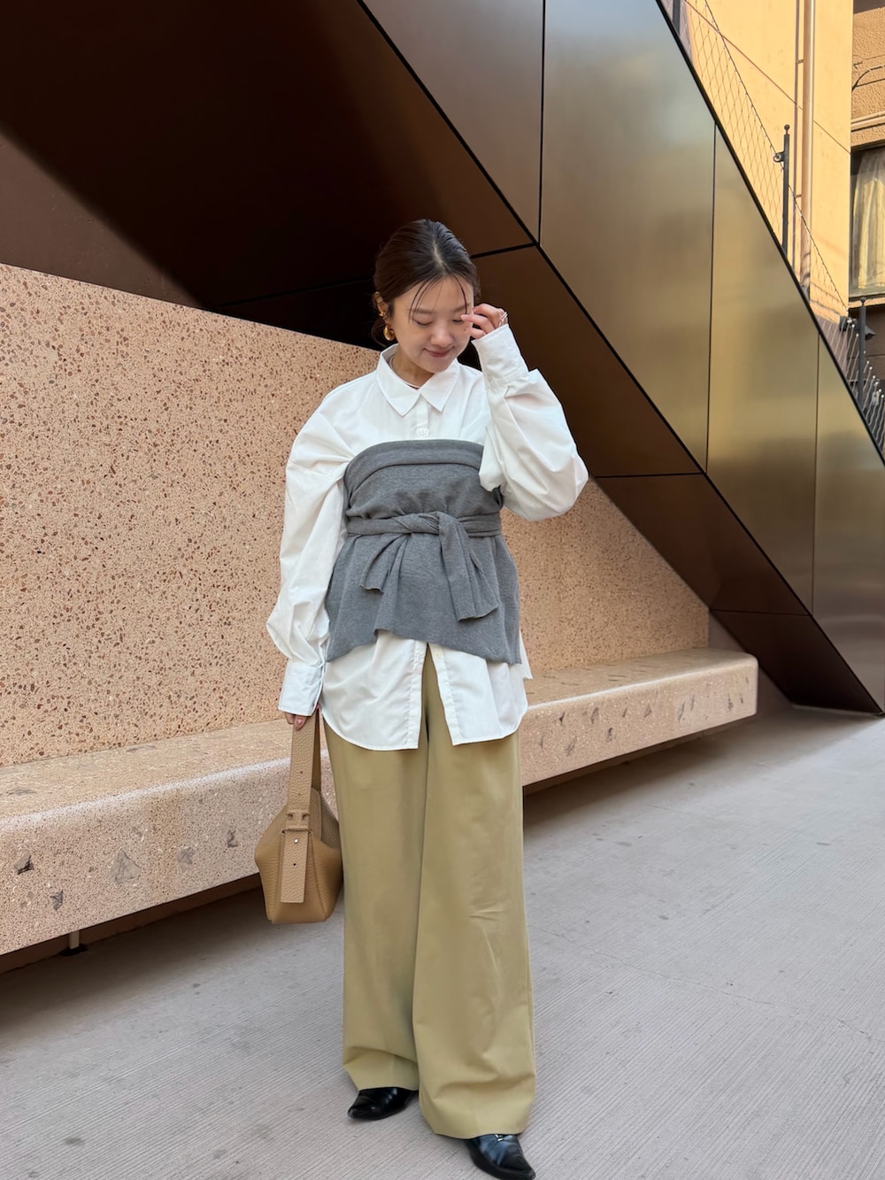 イエロー系のトートバッグを着用したレディースの春コーディネートの2枚目の写真