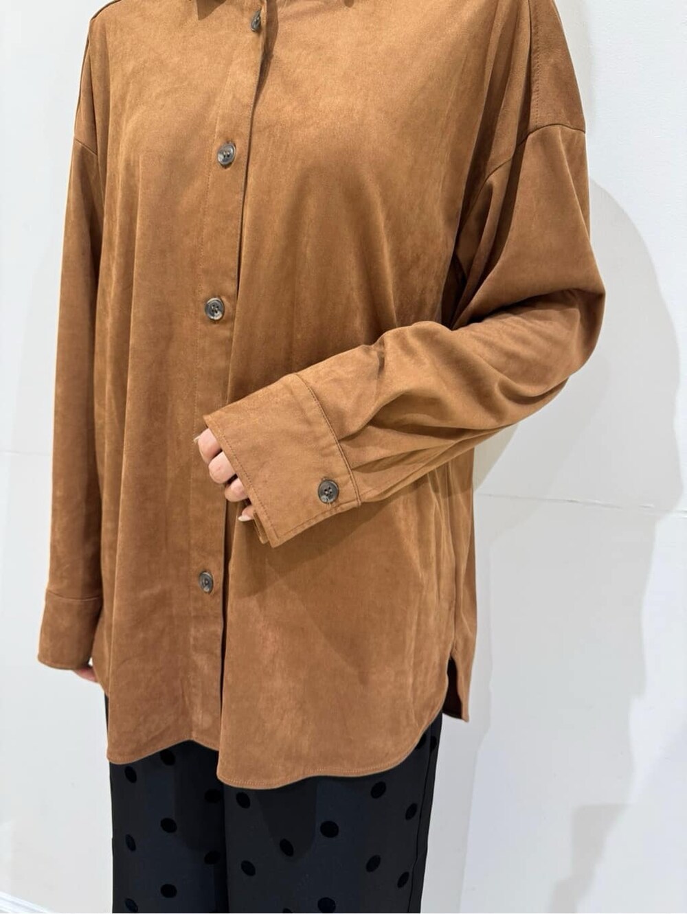 イエロー系のシャツ/ブラウス、ブラック系のその他パンツ、ブルー系のキャップを着用したレディースの秋コーディネートの5枚目の写真