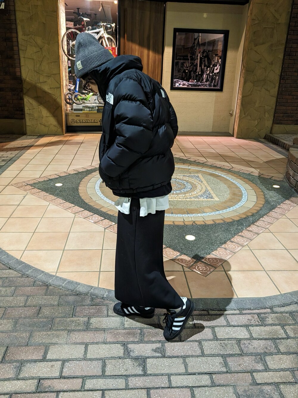 ブラック系のダウンジャケット/コート、ブラック系のスウェット、ブラック系のスニーカーを着用したレディースの冬コーディネートの2枚目の写真