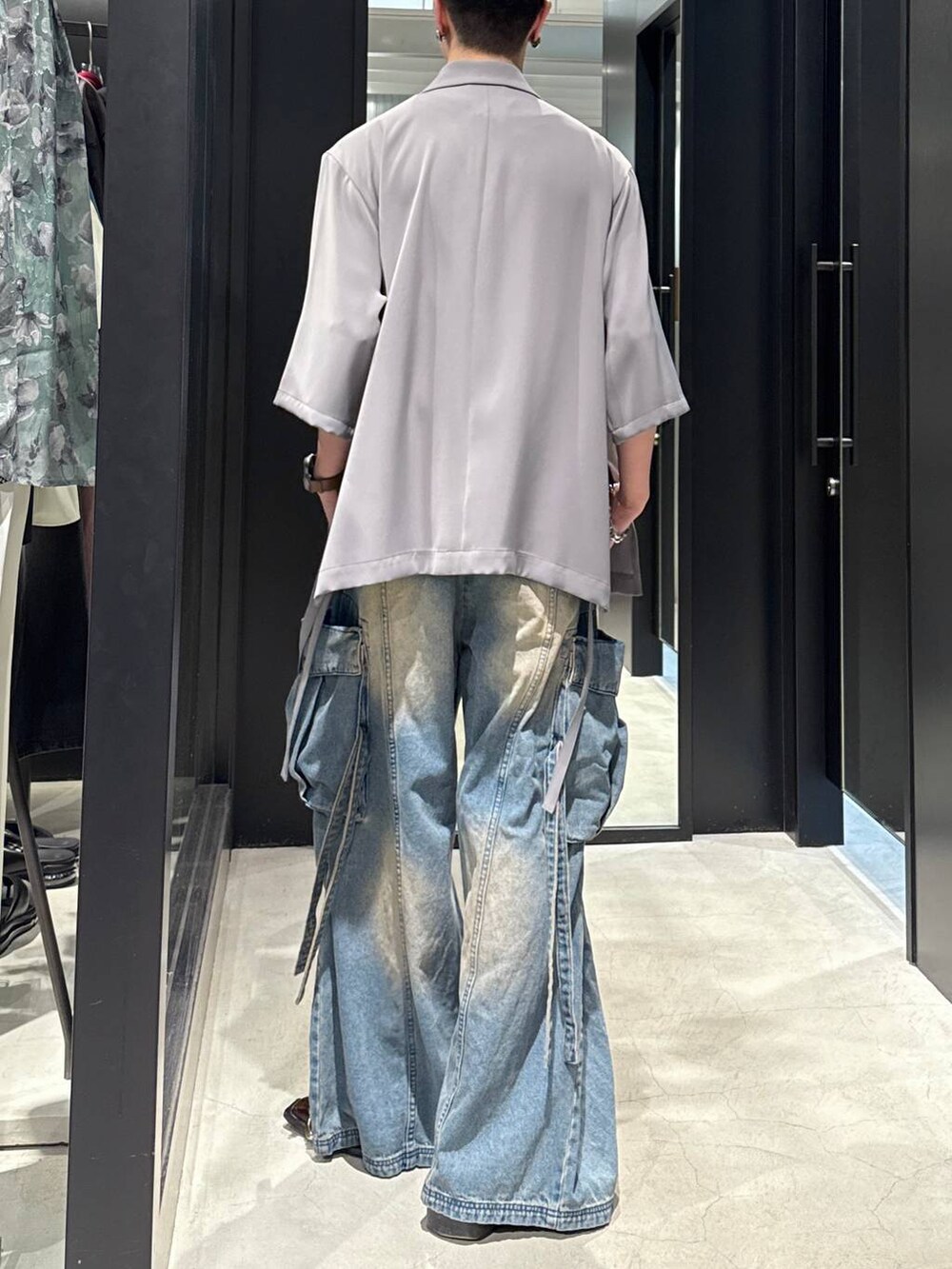 ブルー系のカーゴパンツ、グレー系のテーラードジャケット、ブラック系のタンクトップを着用したメンズの春コーディネートの2枚目の写真