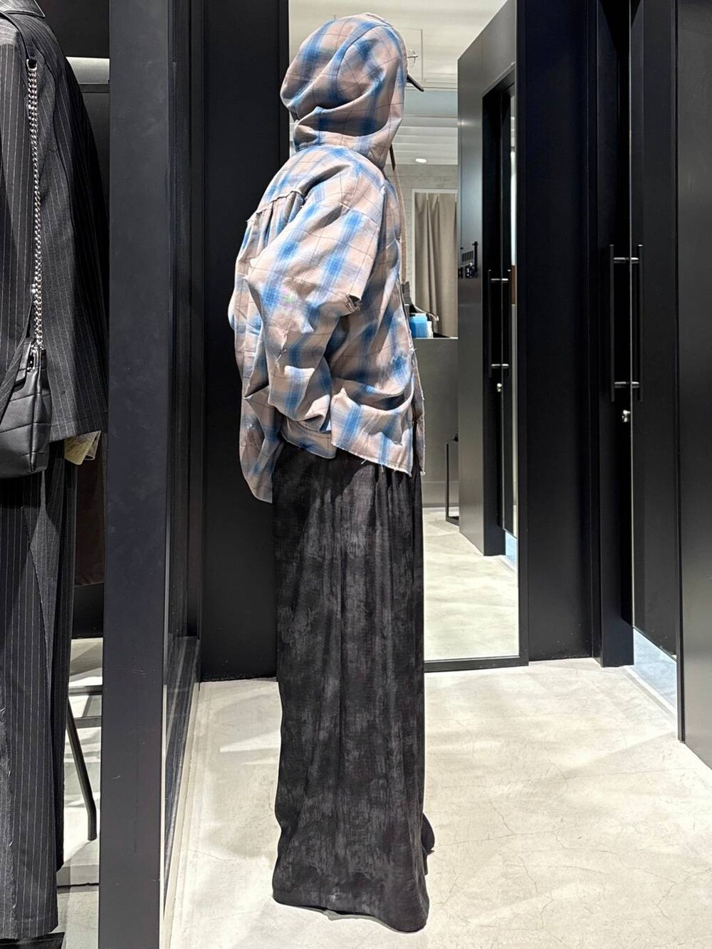 ブラック系のTシャツ/カットソー、グレー系のスラックス、ブラック系のキャップを着用したメンズの冬コーディネートの2枚目の写真