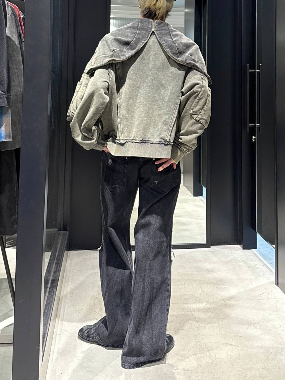 ブラック系のデニムパンツ、ブラック系のキャップ、シルバー系のネックレスを着用したメンズの冬コーディネートの3枚目の写真