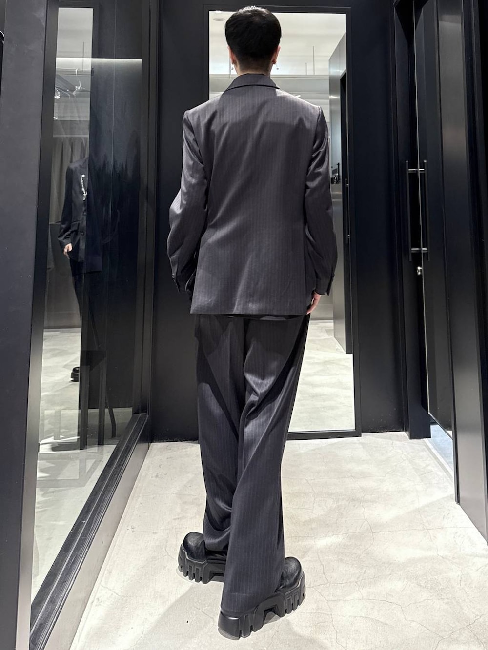 ブラック系のシャツ/ブラウス、ブラック系のスラックス、ブラック系のテーラードジャケットを着用したメンズの冬コーディネートの3枚目の写真