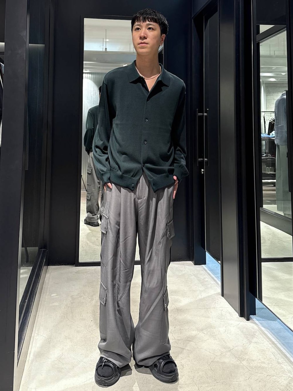 ブラック系のサンダル、ブラック系のタンクトップ、グレー系のカーゴパンツを着用したメンズの夏コーディネートの4枚目の写真