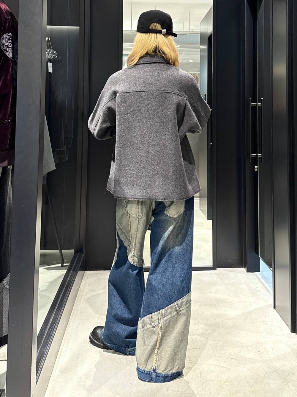 グレー系のブルゾン、ブルー系のデニムパンツ、ブラック系のその他シューズを着用したメンズの秋コーディネートの3枚目の写真