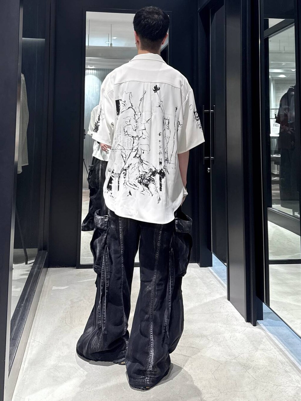 ブラック系のカーゴパンツ、ブラック系のサンダル、ブラック系のタンクトップを着用したメンズの夏コーディネートの3枚目の写真