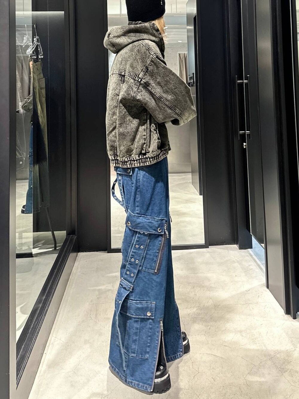 グリーン系のブルゾン、ブラック系のその他シューズ、ブルー系のデニムパンツを着用したメンズの秋コーディネートの2枚目の写真