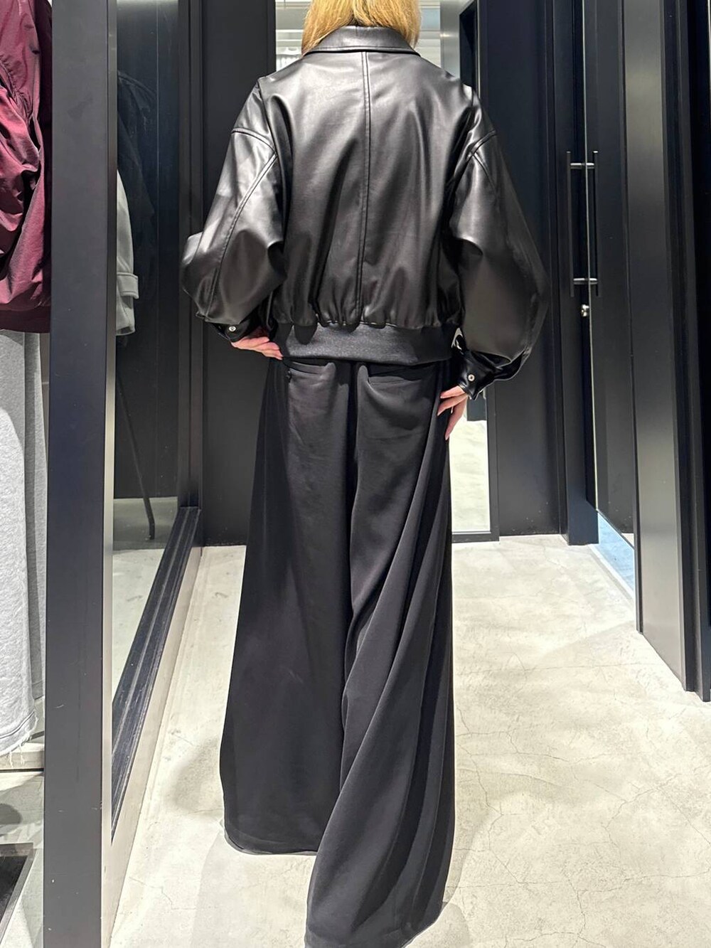 ブラック系のブルゾン、ブラック系のスラックス、ブラック系のキャップを着用したメンズの秋コーディネートの3枚目の写真