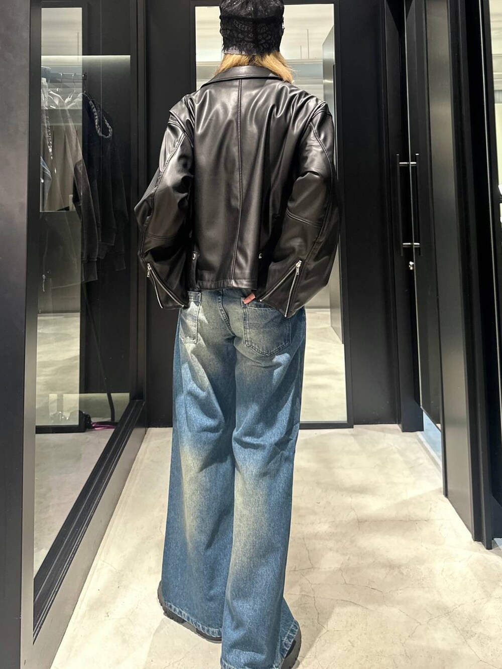 ブルー系のデニムパンツ、ブラック系のライダースジャケット、シルバー系のネックレスを着用したメンズの秋コーディネートの3枚目の写真