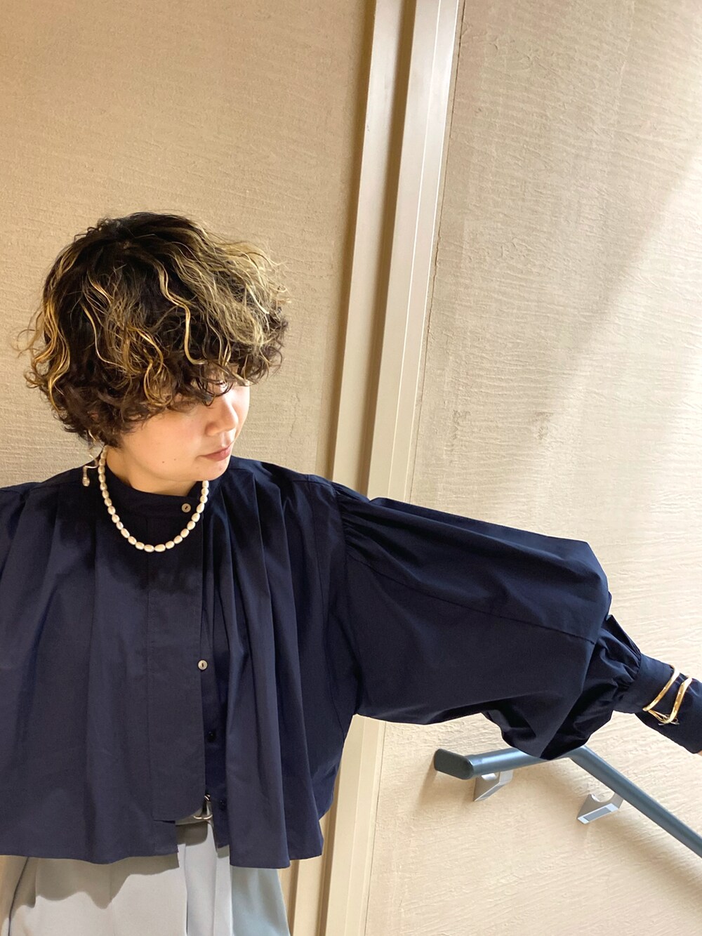 グリーン系のその他パンツ、ブルー系のシャツ/ブラウス、ブラック系のハンドバッグを着用したレディースの冬コーディネートの2枚目の写真