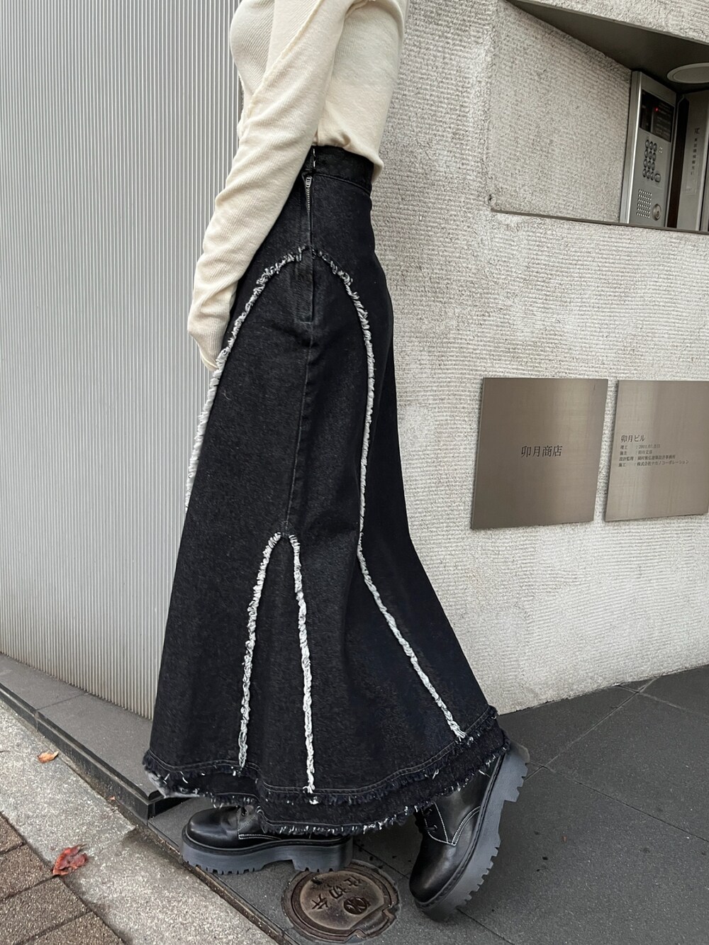 ホワイト系のTシャツ/カットソー、ブラック系のデニムスカートを着用したレディースの秋コーディネートの7枚目の写真