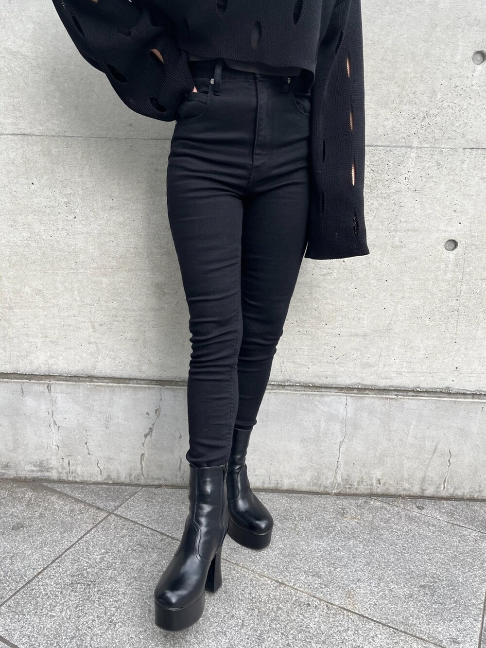 ホワイト系のブルゾン、ブラック系のニット/セーター、ブラック系のデニムパンツを着用したレディースの冬コーディネートの10枚目の写真