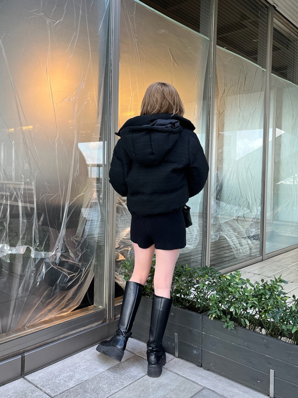 ブラック系のダウンジャケット/コート、ブラック系のスウェットパンツ、ベージュ系のニット/セーターを着用したレディースの冬コーディネートの3枚目の写真
