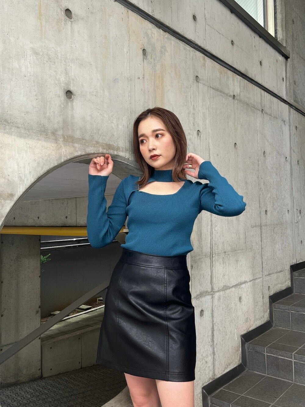 ホワイト系のブルゾン、ブルー系のニット/セーター、ブラック系のブーツを着用したレディースの秋コーディネートの7枚目の写真