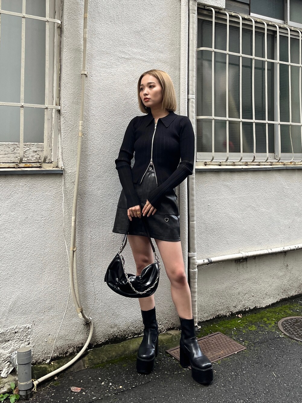 ブラック系のニット/セーター、ブラック系のブーツ、ブラック系のスカートを着用したレディースの冬コーディネートの2枚目の写真