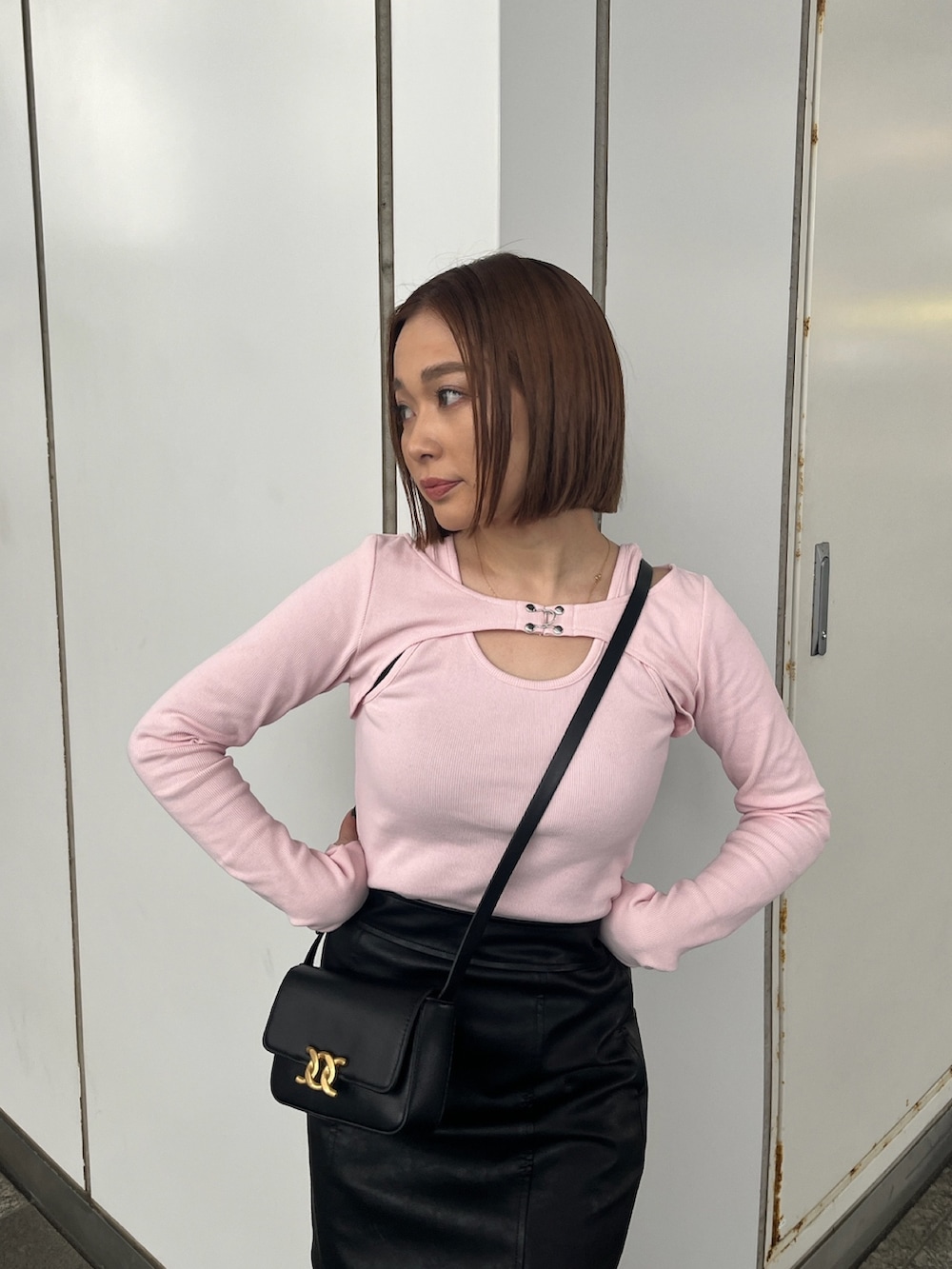 ピンク系のTシャツ/カットソー、ブラック系のスカートを着用したレディースの冬コーディネートの3枚目の写真