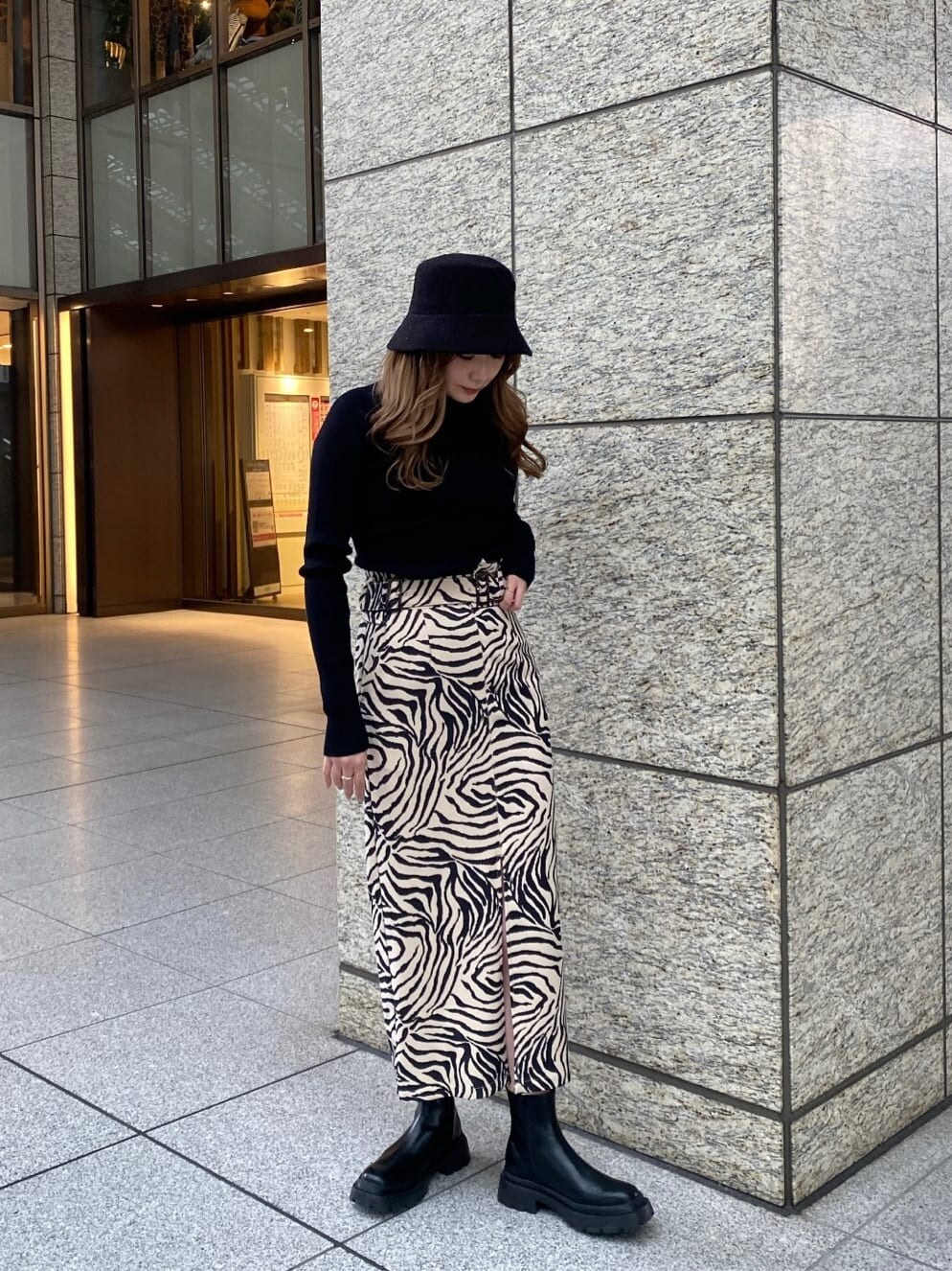 ブラック系のブーツ、その他のスカート、ブラック系のニット/セーターを着用したレディースの春コーディネートの3枚目の写真