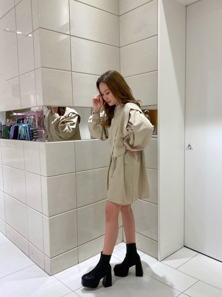 ブラウン系のブーツ、ブラック系のブーツ、ベージュ系のワンピースを着用したレディースの冬コーディネートの4枚目の写真