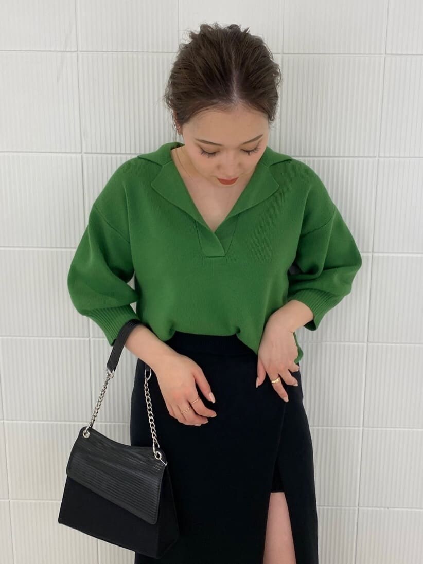 ブラック系のブーツ、ブラック系のハンドバッグ、ブラック系のスカートを着用したレディースの春コーディネートの5枚目の写真