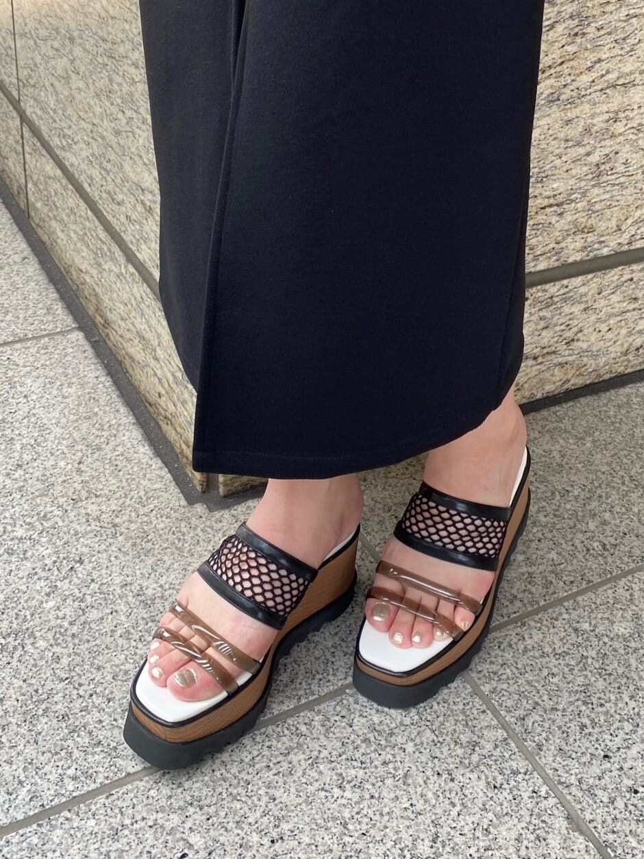 ブラック系のスカート、ホワイト系のTシャツ/カットソー、その他のサンダルを着用したレディースの春コーディネートの8枚目の写真